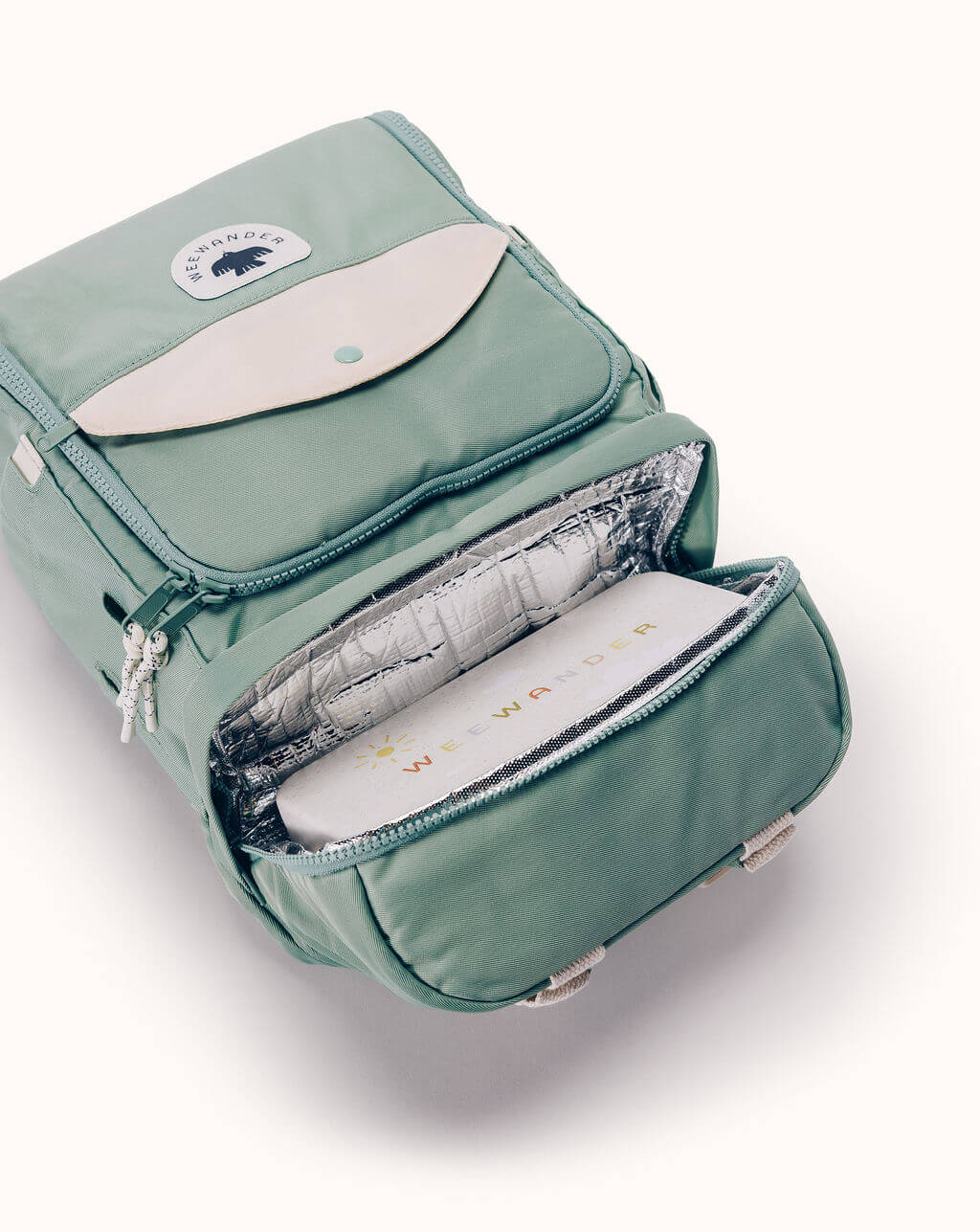 WeeWander green backpack open showing insulated compartment with snack box inside
