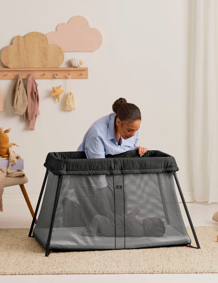 BabyBjörn Travel Crib Light in black with mesh sides and included carry bag
